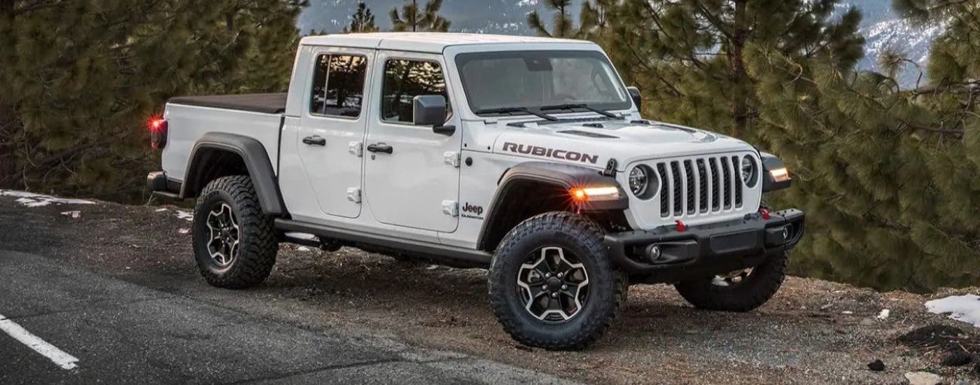 White 2023 Jeep Gladiator parked on the side of the road