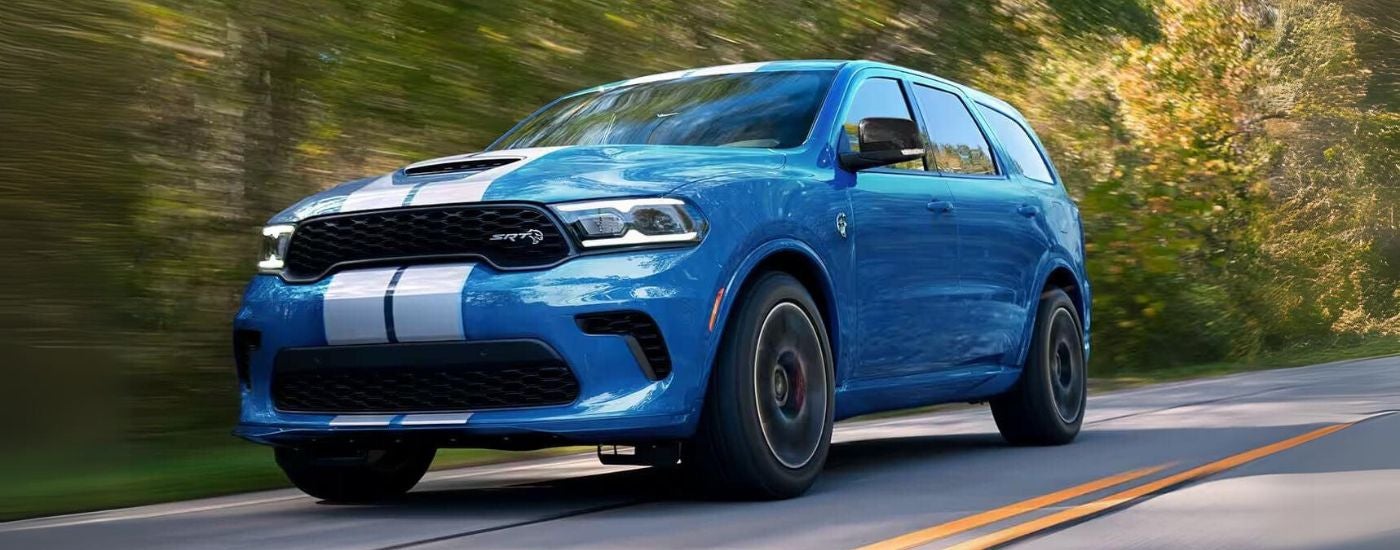 A blue 2024 Dodge Durango SRT driving on a highway