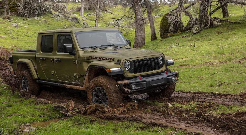 Green 2026 Jeep Gladiator Rubicon driving off-road.