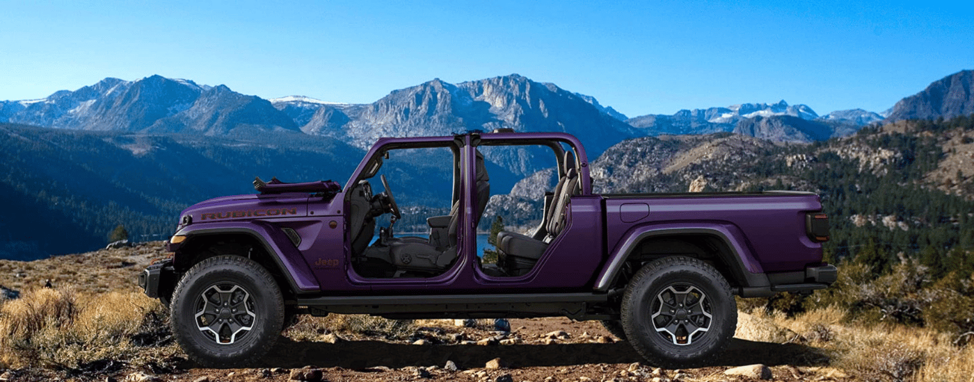 Purple 2026 Jeep Gladiator parallel parked in front of mountains