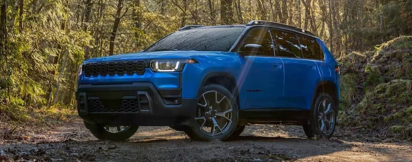 A blue 2026 Jeep Cherokee parked offroad.