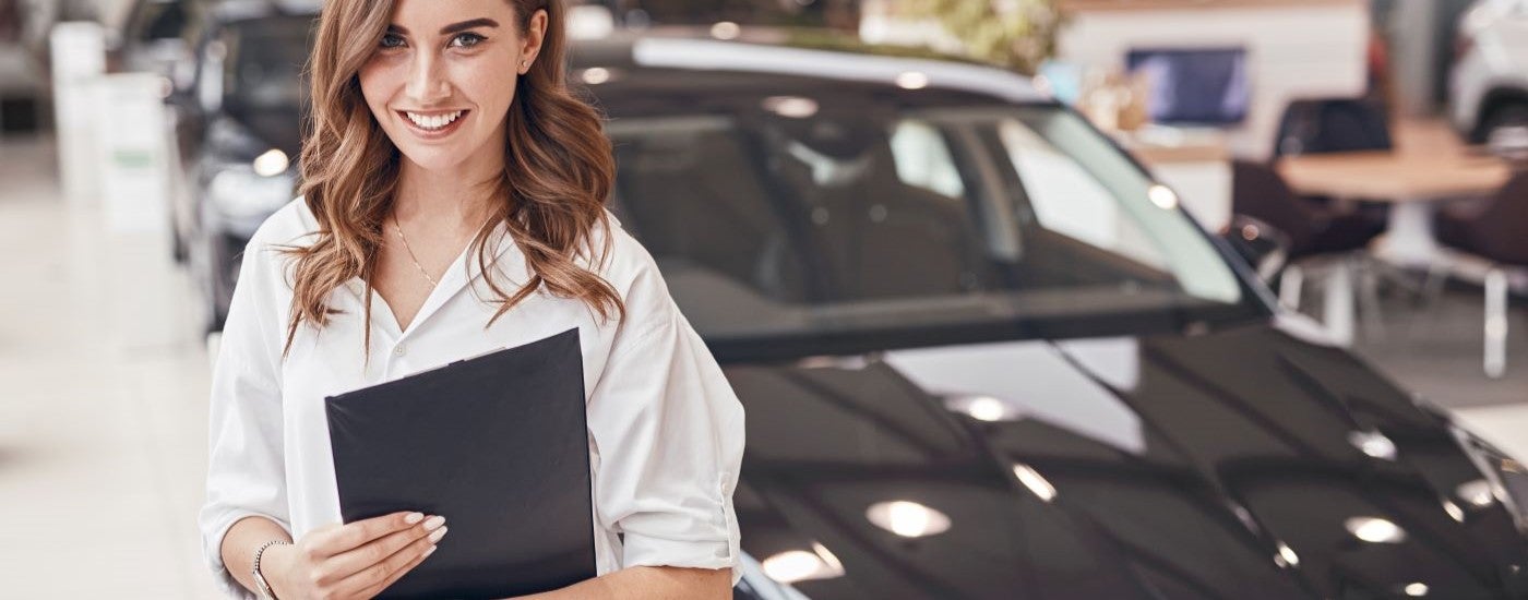 Smiling sales person at a dealership