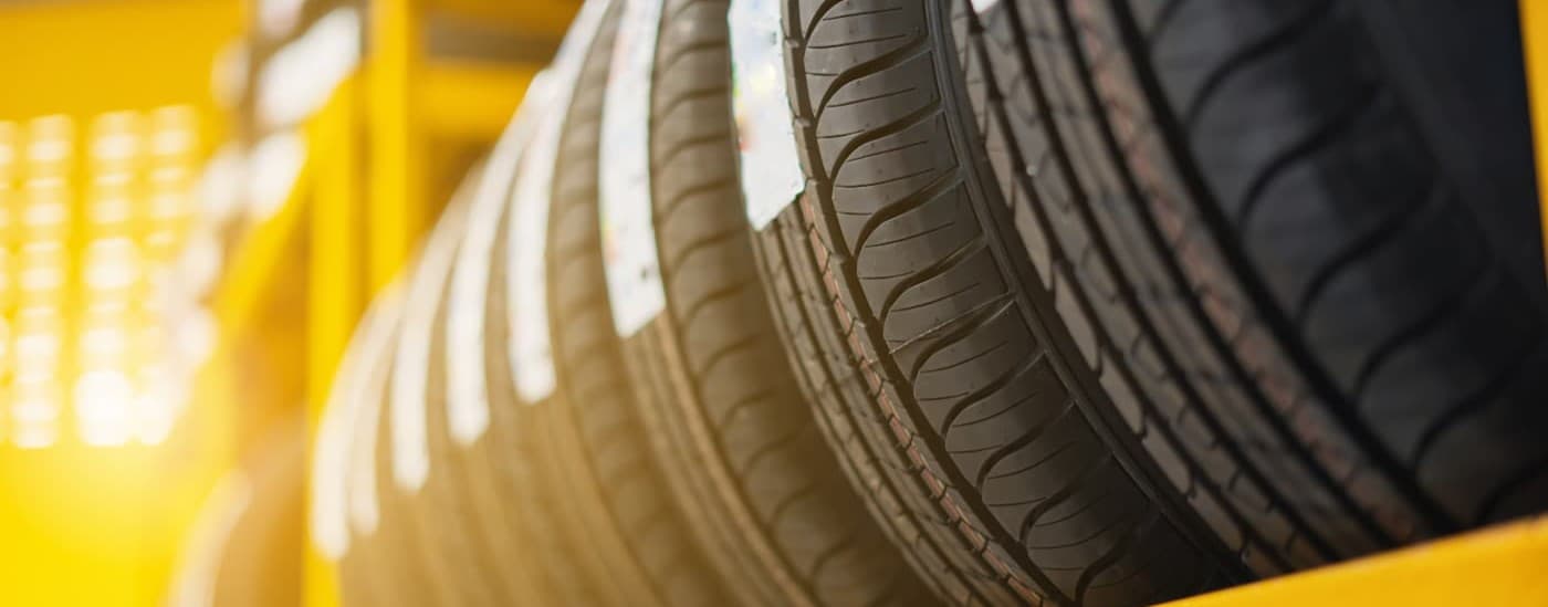 Several tires on a tire rack.