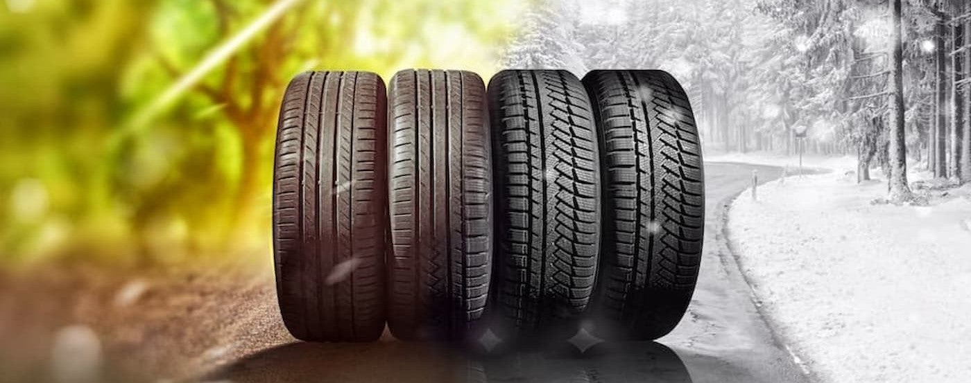 Four tires lined up on a road.